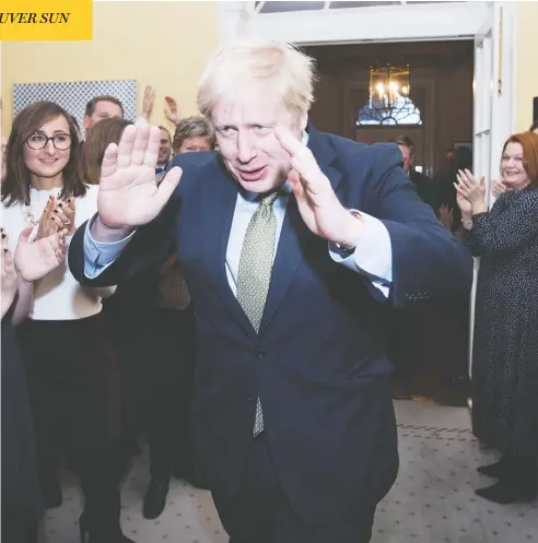  ?? STEFAN ROUSSEAU / WPA POOL / GETTY IMAGES ?? Prime Minister Boris Johnson arrives back at 10 Downing Street Friday after getting the Queen’s permission to form the next British government.