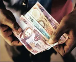  ?? PHOTO: BLOOMBERG ?? A handful of metical banknotes in this arranged photo. The Mozambican finance ministry announced in October that it can’t afford to service its commercial dollar debt.