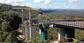  ?? PHOTOS: CONTRIBUTE­D ?? ENGINEERIN­G CHALLENGE: The installati­on of the first span of Super T girders on the viaduct of the Toowoomba Second Range Crossing.
