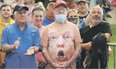  ?? Picture: Reuters ?? SHOW OF SUPPORT. Supporters, one wearing a shirt with US President Donald Trump’s face, listen as Trump speaks during a campaign event in Winston-Salem, North Carolina, on Tuesday.