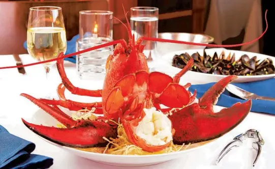  ?? JORDAN VILONNA ?? PB Catch Seafood & Raw Bar in Palm Beach will have two special menu items for Father’s Day: a Steamed Maine Lobster and a Surf & Turf.