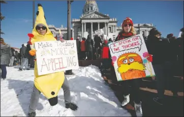  ?? The Associated Press ?? TEACHER STRIKE: Hung Huynh, left, a teacher at Castro Elementary, joins his colleagues during a strike rally on the west steps of the state Capitol, Monday, in Denver. The strike is the first for teachers in Denver since 1994 and centers on base pay.