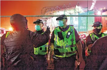  ??  ?? Police guarding fans outside Celtic Park following Celtic’s Betfred Cup defeat to Ross County yesterday