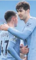  ??  ?? John Stones celebrates with Phil Foden after City’s win yesterday