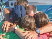  ??  ?? ABOVE: The skippers gather for one last photo call before the start BELOW: Finnish sailor Tapio Lehtinen gathers his family for a group hug, before finally stepping aboard