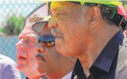  ?? JIM YOUNG/ AFP/ GETTY IMAGES ?? The Rev. Michael Pfleger ( from left), Police Supt. Eddie Johnson and the Rev. Jesse Jackson on Saturday.