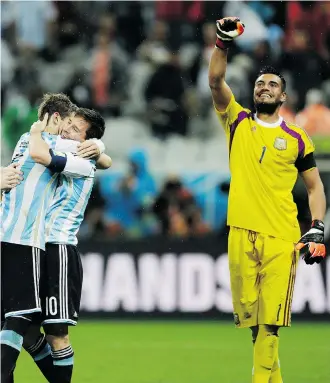  ?? Natacha Pisarenko/The Associated Press ?? Argentina’s Lionel Messi is hugged by teammate Lucas Biglia while goalkeeper Sergio Romero celebrates after they defeated the Netherland­s 4-2 in penalties on Wednesday, advancing to the World Cup final against Germany.