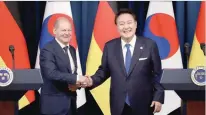  ?? Reuters ?? Olaf Scholz shakes hands with Yoon Suk Yeol after their joint press conference at the Presidenti­al Office in Seoul, South Korea. —