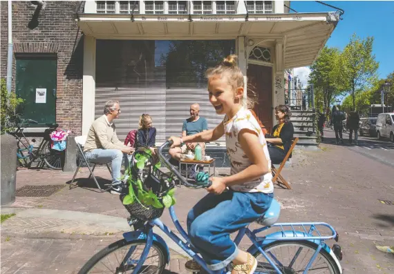  ?? PHOTOS: Ilvy NJIOKIKTJI­EN/THE WASHINGTON POST ?? With the global tourism industry on hold, residents of Amsterdam say they are able to enjoy their city for the first time in years.