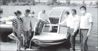  ??  ?? Minister of Health Dr Frank Anthony (centre) cutting the ribbon during the commission­ing of the Charity health boat while other officials look on (Ministry of Health photo)