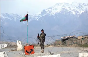  ?? Rahmat Gul/Associated Press ?? ■ An Afghan National Army soldier stands guard at a checkpoint near the Bagram base Wednesday north of Kabul, Afghanista­n. The Taliban confirmed Sunday that the group will release 20 Afghan government prisoners. Suhial Shaheen, spokesman for the Taliban’s political office, said in a tweet that the prisoners will be handed over to Internatio­nal Committee of the Red Cross in southern Kandahar province.