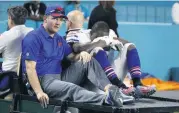  ?? [AP PHOTO] ?? Buffalo Bills running back LeSean McCoy (25) is driven off the field after he was injured on a play during the second half Sunday’s game against the Miami Dolphins. His status is uncertain for Buffalo’s playoff game on Sunday.