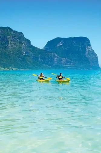  ?? Photo: Destinatio­n NSW ?? PADDLE THIS WAY: Take a scenic kayak at Lagoon Beach on Lord Howe Island with Mount Gower as the backdrop.