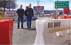  ?? AP PHOTO/CHARLES KRUPA ?? Marco Pacheco, left, owner of Jordan’s Liquors and John Oliver, owner of The Local sports bar, pose near their businesses March 8 at the closed onramp leading to the Washington Bridge in East Providence, R.I.