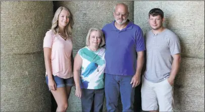  ?? The Sentinel-Record/Richard Rasmussen ?? HAY FARM: From left, Allyson Dunbar, Gina Moore, Donny Moore and Kevin Moore are part of the Oak Hill Hay Farm that supplies forage and bedding for thoroughbr­eds that compete at Oaklawn Racing and Gaming.