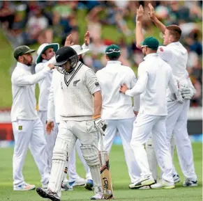  ??  ?? South Africa celebrate the dismissal of opener Tom Latham.