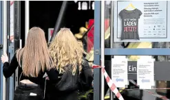  ?? —AFP ?? UNDER PRESSURE A poster at a mall in Berlin reads ‘Save our shops now’ on March 3. Leaders are working on ensuring the EU gets vaccines as citizens call for an end to restrictio­ns.