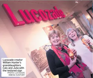  ?? PHOTO: LUCOZADE RIBENA SUNTORY ?? Lucozade creator William Hunter’s granddaugh­ters Caly and Julia with the restored sign