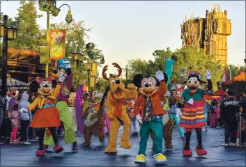  ?? PHOTO BY JEFF GRITCHEN, ORANGE COUNTY REGISTER — SCNG ?? Mickey Mouse joins other costmed characters as they perform at Disney California Adventure in December 2019.