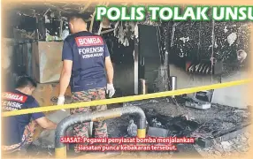  ??  ?? SIASAT: Pegawai penyiasat bomba menjalanka­n siasatan punca kebakaran tersebut.