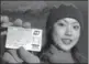  ?? XU HAIFENG / FOR CHINA DAILY ?? A Chinese traveler shows her credit card jointly issued by the Shanghai Pudong Developmen­t Bank and Citibank.