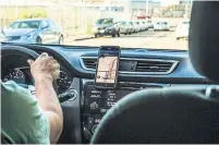  ?? CHRISTIE HEMM KLOK THE NEW YORK TIMES FILE PHOTO ?? Rather than classify drivers as employees, Uber and Lyft say they adopt “a system of worker-determined benefits — from paid time off to retirement planning to lifelong learning.”