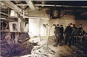  ?? RICHARD DREW / AP, FILE ?? New York City police and firefighte­rs inspect the bomb crater inside an undergroun­d parking garage of New York’s World Trade Center on Feb. 27, 1993, the day after an explosion tore through it.