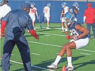  ??  ?? Defensive coordinato­r Wesley McGriff makes sure that Armani Linton (29) follows through on the drill during practice at Ole Miss. BILL BARKSDALE/SPECIAL TO THE C, BILL BARKSDALE/SPECIAL TO THE CL