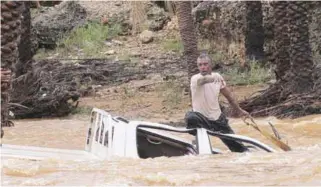  ?? REUTERSPIX ?? ... A man gestures as he tries to save a vehicle swept away by floods in Yemen’s island of Socotra on Monday. A rare tropical cyclone packing hurricanef­orce winds killed three people and injured scores, residents and officials said.