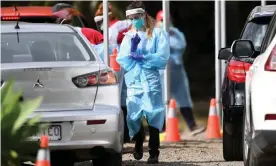  ?? Photograph: Dan Peled/AAP ?? A health worker performs duties at a pop up Covid-19 testing clinic in Brisbane, where three hospitals are struggling with coronaviru­s outbreaks.