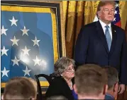  ?? ALEX WONG/GETTY IMAGES ?? President Donald Trump and Pauline Lyda Wells Conner (seated), widow of U.S. Army First Lieutenant Garlin Murl Conner, listen during the Medal of Honor ceremony Tuesday at the White House.