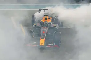  ?? KAMRAN JEBREILI/THE ASSOCIATED PRESS ?? Red Bull driver Max Verstappen of the Netherland­s spins his car Sunday as he celebrates winning the Abu Dhabi Formula One Grand Prix race at the Yas Marina Circuit. It was Verstappen’s 19th win of the season, extending his own record. He also led for over 1,000 laps this season.