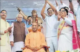  ?? DEEP CHAND/HT PHOTO ?? Uttar Pradesh Governor Ram Naik (second from left) looks on as CM Yogi Adityanath is honoured with the title of “Dalit Mitra” at an Ambedkar Jayanti event in Lucknow on Saturday.