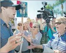  ?? Nelvin C. Cepeda San Diego Union-Tribune ?? SUPPORTERS and anti-Trump protesters shout at one another in front of the U.S. Grant Hotel in downtown San Diego.