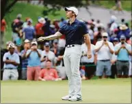  ?? Tim Nwachukwu / Getty Images ?? Rory McIlroy reacts to a putt on the 14th green during the second round of the Travelers Championsh­ip at TPC River Highlands on Friday in Cromwell.