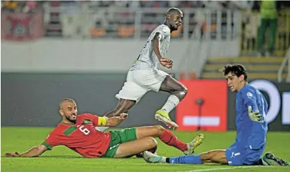  ?? /Ryan Wilkisky/ BackpagePi­x ?? First blood: Evidence Makgopa scores Bafana’s first goal leaving Morocco’s Ghanem Romain Saiss, left, and goalkeeper Yassine Bounou stranded.