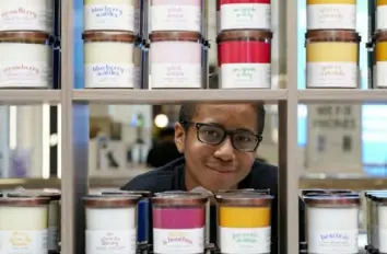  ?? Bonnie Jo Mount photos ?? Alejandro Buxton, 12, runs the Smell of Love Candles kiosk at Tysons Corner Center in Virginia. He started making natural candles in the family kitchen because his mom got headaches from candles that contained chemicals.