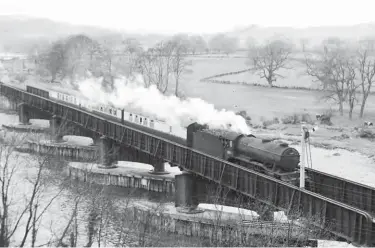  ?? Neville Stead Collection/Transport Treasury ?? Crossing the River Tyne on approach to Border Counties Junction is Gresley ‘K3’ class 2-6-0 No 61897, a St Margarets-allocated locomotive that has worked through, and the stock is different too, ex-LNER and cascaded down from main line work. In due course the condition of the Border Counties Bridge and the predicted cost of repairs was a major factor in the abandonmen­t of this ex-NBR route, with passenger trains ceasing to run on 13 October 1956, although the passage of goods trains continued through to 1 September 1958.