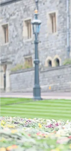  ??  ?? TRIBUTES: The Countess of Wessex, Lady Louise Windsor and the Earl of Wessex view some of the flowers outside St George’s Chapel, and, right, Rev Kenneth MacKenzie of Crathie Kirk.