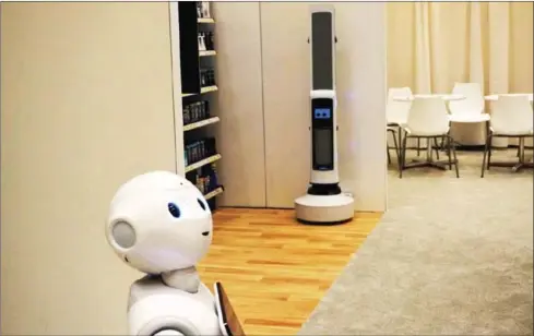  ?? ROBERT LEVER/AFP ?? Pepper of SoftBank Robotics (left) and Tally of Simbe Robotics (right) are teaming up to work with retailers: Pepper interacts with customers while Tally scans the shelves to monitor inventory levels in this demo from SoftBank at the Consumer Electronic­s Show in Las Vegas, USA.