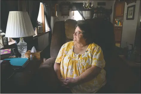  ?? (AP/Justin Merriman) ?? Doris Kelley, 57, sits in her home in Ruffs Dale, Pa. Kelley was one of the first patients in a University of Pittsburgh Medical Center trial for covid-19. “It felt like someone was sitting on my chest and I couldn’t get any air,” Kelley said of the disease.