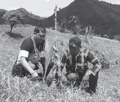  ??  ?? GOV. Edwin Jubahib plants a coconut tree to mark his historic visit to the isolated tribal village of Sitio Tapayanon, which is a former NPA lair. Assisting him is Tribal Chieftain Datu Bansing Balanban. 1Lt. AVJ Celestial