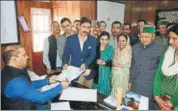  ?? DEEPAK SANSTA/HT ?? Vikramadit­ya Singh (in a blue jacket) files his nomination along with his father and chief minister, Virbhadra Singh, and other members of his family in Shimla on Monday.