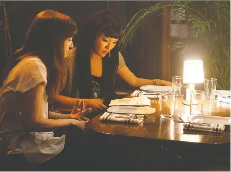  ?? STX FILMS ?? Hustlers, a new movie by director Lorene Scafaria, left, and starring Constance Wu, tells the story of strippers who steal from their clients.