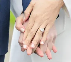  ?? DOMINIC LIPINSKI / PA VIA THE ASSOCIATED PRESS ?? Meghan Markle wears her engagement ring as she holds hands with Britain’s Prince Harry.