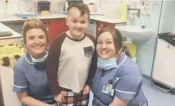  ??  ?? Charlie Clayton, nine, had part of a 3cm-large tumour removed from his brain in a four-and-a-half hour operation. Pictured at Southampto­n Hospital with the nurses that cared for him