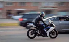  ?? ?? A motorcycli­st rides along Woodward Avenue in Birmingham. Officials say many motorcycle­s on Woodward have been modified to make more noise.