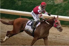  ?? The Associated Press ?? ■ Sonny Leon celebrates after riding Rich Strike to victory in the 148th running of the Kentucky Derby May 7 at Churchill Downs in Louisville, Ky.