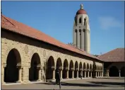  ?? BEN MARGOT/ASSOCIATED PRESS ?? People walk on the Stanford University campus beneath Hoover Tower. Some see higher education being at risk.