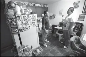  ?? AP/CHARLIE NEIBERGALL ?? Alejandro Lopez (left), of Iowa talks last month with his son Jonathan, 18, about the teen’s applicatio­n for asylum.